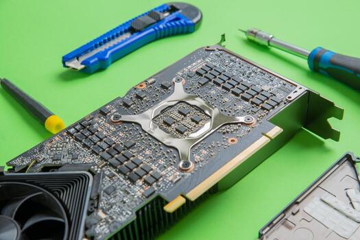 Open graphics card showing chips, MOSFETs, and power section. Clear view of components on PCB. Tools beside photo
