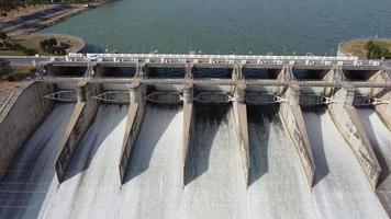 An aerial view over the Pasak Jolasid dam, Lopburi Province, Thailand. Tracking the movement of the floodgates that are releasing water into rural canals in enormous amounts of water. video