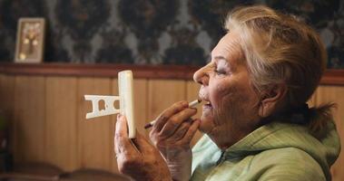 Age make-up for a woman of 84 years. Using a mirror and lipstick video