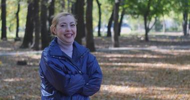 Happy girl in the autumn park laughs. slow motion video