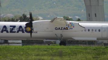 ALMATY, KAZAKHSTAN MAY 4, 2019 - Turboprop passenger aircraft of QAZAQ AIR takeoff at Almaty airport. Tourism and travel concept. video