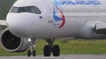 NOVOSIBIRSK, RUSSIAN FEDERATION JULY 15, 2022 - Airplane of Ural Airlines taxiing on the airfield at Tolmachevo Airport, Novosibirsk. Airplane on taxiway, medium shot video