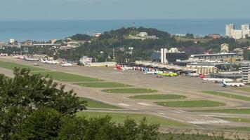 SOCHI, RUSSIA JULY 29, 2022 - Time lapse view of the airport. Daytime traffic at a busy airport. Runway and terminal. Tourism and travel concept video