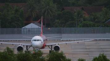 PHUKET, THAILAND NOVEMBER 28, 2019 - Airplane of AirAsia at Phuket airport. Aircraft towing to the runway. Aircraft pre flight preparation. Tourism and travel concept video