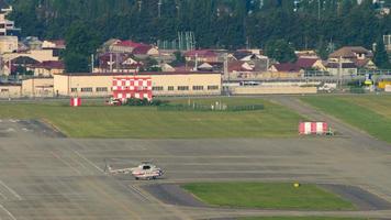 SOCHI, RUSSIA AUGUST 04, 2022 - Russian Mi 8 helicopter rides on the taxiway at Sochi airport, long shot. Transport on the airfield video