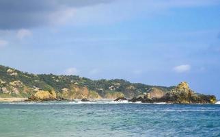 Mazunte Mexico Beautiful paradise beach with mountains cliffs rocks waves. photo