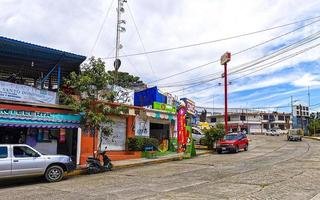 Puerto Escondido Oaxaca Mexico 2022 Colorful streets cars high traffic stores people buildings trade Mexico. photo