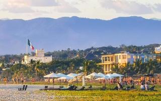 Puerto Escondido Oaxaca Mexico 2022 Colorful golden sunset people wave and beach Puerto Escondido Mexico. photo