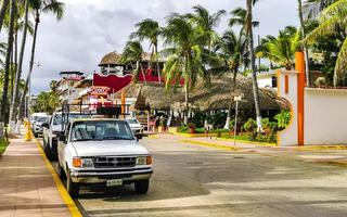 Puerto Escondido Oaxaca Mexico 2022 Colorful streets cars high traffic stores people buildings trade Mexico. photo