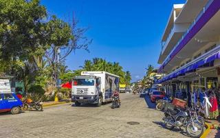 Puerto Escondido Oaxaca Mexico 2022 Colorful streets cars high traffic stores people buildings trade Mexico. photo
