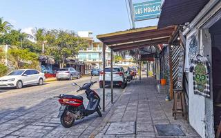 Puerto Escondido Oaxaca Mexico 2022 Colorful streets cars high traffic stores people buildings trade Mexico. photo