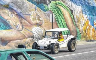 Puerto Escondido Oaxaca Mexico 2022 Colorful streets cars high traffic stores people buildings trade Mexico. photo