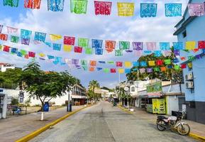 Puerto Escondido Oaxaca Mexico 2022 Colorful streets cars high traffic stores people buildings trade Mexico. photo