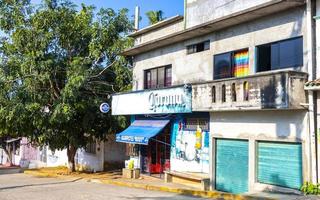 Puerto Escondido Oaxaca Mexico 2022 Colorful streets cars high traffic stores people buildings trade Mexico. photo