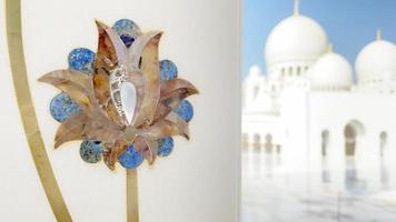 Abu dhabi, UAE, 2022 - close up flowers on columns art exterior details on Grand mosque. Corridors of Grand mosque with nobody in bright sun light video