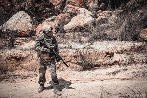 Soldiers of special forces on wars at the desert,Thailand people,Army soldier use laptop for see map with satellite,Using Radio For Communication During Military Operation photo