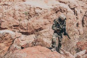 Soldiers of special forces on wars at the desert,Thailand people,Army soldier use laptop for see map with satellite,Using Radio For Communication During Military Operation photo