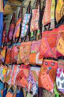 Handmade Souvenir Bags Asian style are hung and display for sales in the shop photo