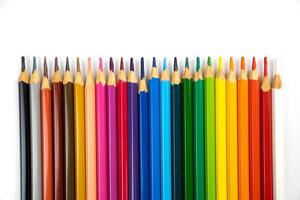 blunt colour pencils are arranged in the line on the white background and ready to paint. photo