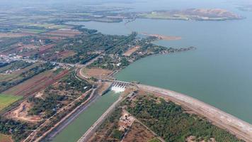 An aerial view over the Pasak Jolasid dam, Lopburi Province, Thailand. Tracking the movement of the floodgates that are releasing water into rural canals in enormous amounts of water. photo