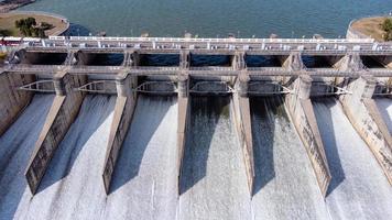 An aerial view over the Pasak Jolasid dam, Lopburi Province, Thailand. Tracking the movement of the floodgates that are releasing water into rural canals in enormous amounts of water. photo