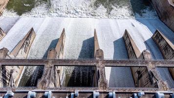 An aerial view over the Pasak Jolasid dam, Lopburi Province, Thailand. Tracking the movement of the floodgates that are releasing water into rural canals in enormous amounts of water. photo