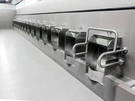 Perspective view and modern design of men urinal in public toilet. Designed and made from stainless steel to prevent rust And modern look. photo