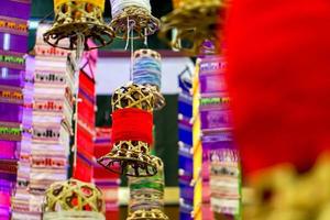 Closeup decorative wicker lantern and Lanna fabric long flags hang on hotel lobby ceiling and blurry background. photo