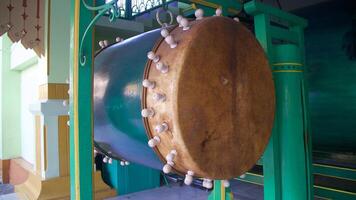 Bedug in mosque, tool used before the call to moslem prayer. drum made of cow leather and wood. photo