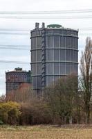 large gasometers in an industrial landscape photo