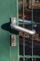 lock and chain at green metal fence photo