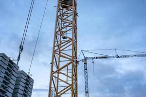 very high construction crane over construction site photo