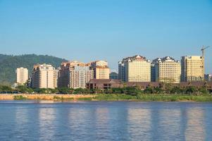 Condominium and other buildings in Bokeo province in Laos view look through Mekong river from Chiang Saen district of Thailand border. photo