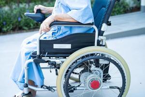 Asian senior or elderly old lady woman patient on electric wheelchair with remote control at nursing hospital ward, healthy strong medical concept photo