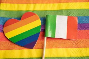 Italy flag on rainbow background symbol of LGBT gay pride month  social movement rainbow flag is a symbol of lesbian, gay, bisexual, transgender, human rights, tolerance and peace. photo