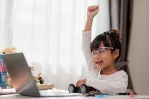 Asia students learn at home in coding robot cars and electronic board cables in STEM, STEAM, mathematics engineering science technology computer code in robotics for kids concept. photo