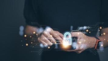 Cybersecurity and privacy concepts to protect data. Lock icon and internet network security technology. Woman protecting personal data on smart phone with virtual screen interfaces. photo