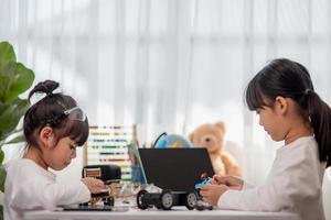 Asia students learn at home in coding robot cars and electronic board cables in STEM, STEAM, mathematics engineering science technology computer code in robotics for kids concept. photo