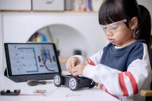 Asia students learn at home in coding robot cars and electronic board cables in STEM, STEAM, mathematics engineering science technology computer code in robotics for kids concept photo