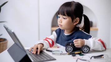 Asia students learn at home in coding robot cars and electronic board cables in STEM, STEAM, mathematics engineering science technology computer code in robotics for kids concept photo