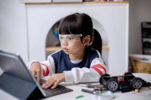 Asia students learn at home in coding robot cars and electronic board cables in STEM, STEAM, mathematics engineering science technology computer code in robotics for kids concept photo