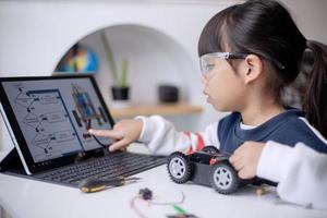 Asia students learn at home in coding robot cars and electronic board cables in STEM, STEAM, mathematics engineering science technology computer code in robotics for kids concept photo