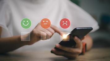 Customer Experience dissatisfied Concept, Unhappy Businessman Client with Sadness Emotion Face on smartphone screen, Bad review, bad service dislike bad quality, low rating, social media not good. photo