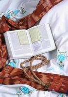 The book of the Qur'an is opened, placed on the cloth used to perform the prayer photo