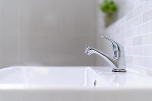The bathroom faucet is turned off to save water energy and protect the environment. water saving concept photo