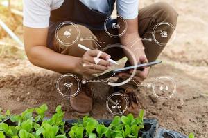 Smart farmer using application by smartphone concepts modern agricultural technology and visual icon. photo