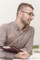 Project Manager Makes a Presentation for a Young Diverse Creative Team in Meeting Room in an Agency. photo