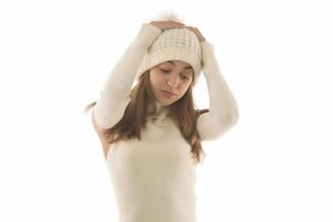 Smiling funny young positive woman 20s in warm white basic sweater hat posing in studio photo