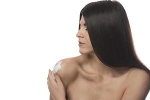 Body Care. Woman Applying Moisturizing Lotion Or Cream on her body photo