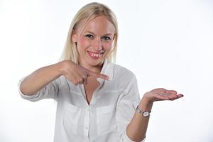 woman pointing on imaginary object. Isolated on white background photo